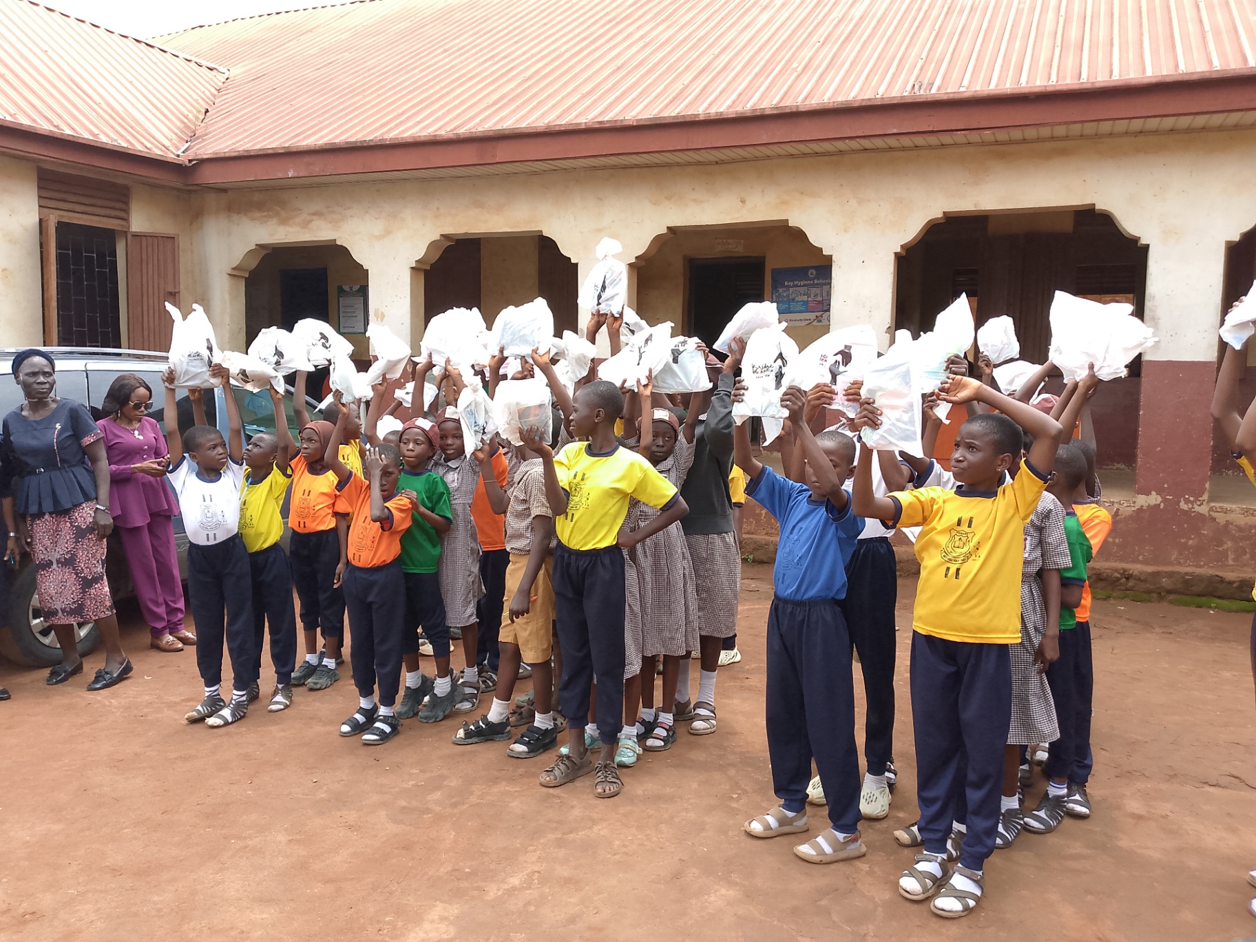 Children raising care packages in celebration